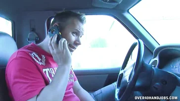 Busty redhead gives a handjob to the supermarket delivery man.